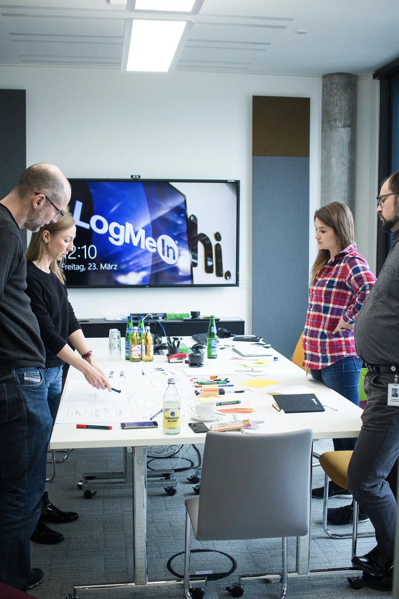 A co-design workshop session with a client, designer, researcher, and lead engineer around a table